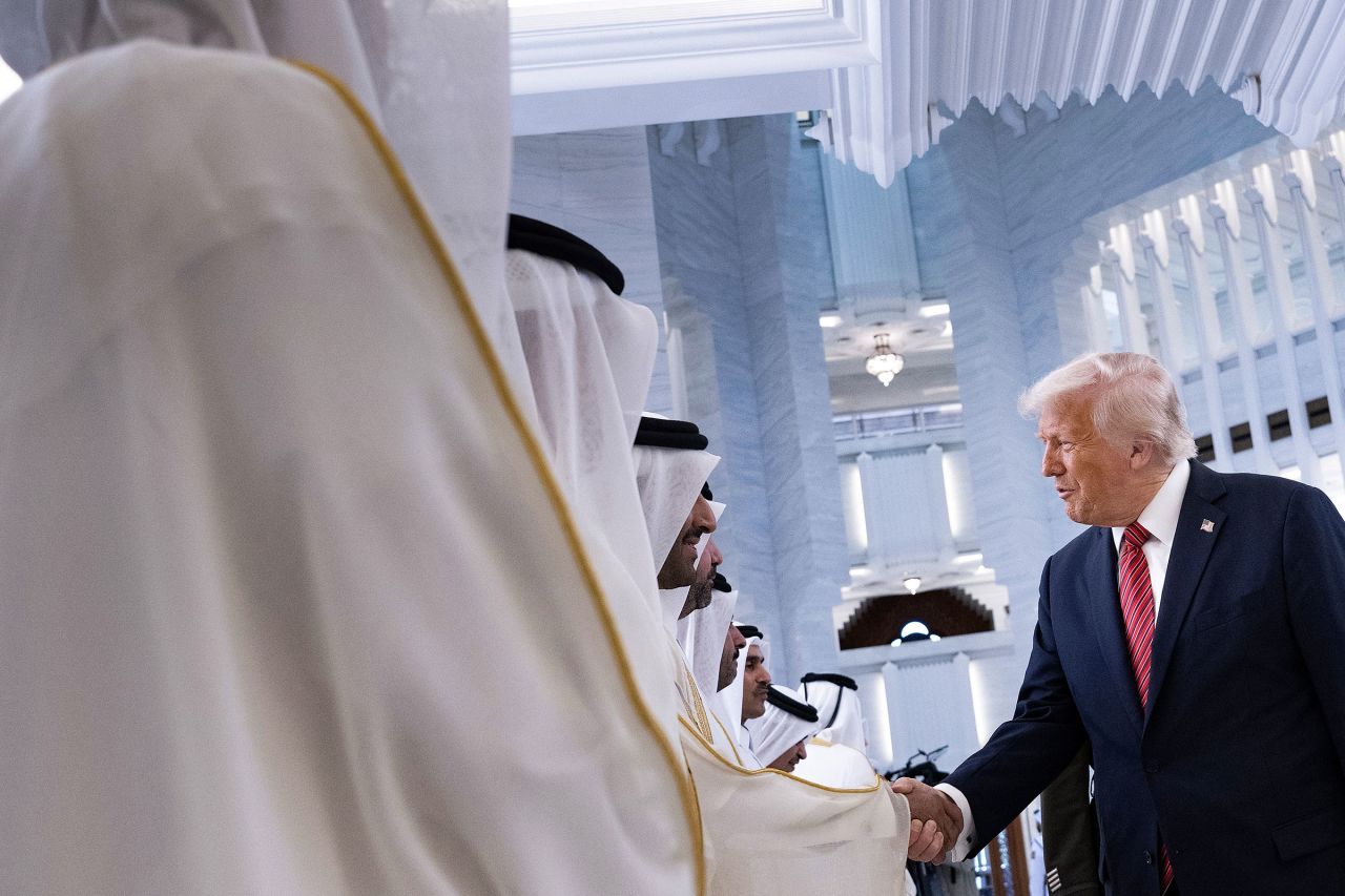 President Donald Trump shakes hands with Qatari officials upon his arrival to meet with Qatar's Emir Sheikh Tamim bin Hamad al-Thani in Doha on May 14.