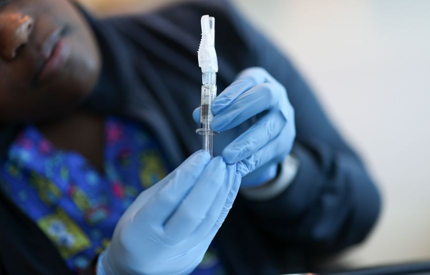 In this photo illustration, Ruth Jones, an immunization nurse, holds a Covid-19 vaccine in Miami on May 29.