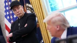 Elon Musk listens as President Donald Trump speaks to reporters in the Oval Office of the White House on May 30, in Washington, DC.