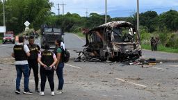Police officers work at the site where a bus exploded in front of a police station in Villa Rica, Cauca department, Colombia, on June 10.