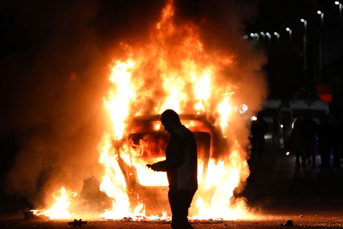A vehicle is set alight during disorder in Ballymena, Northern Ireland, on June 10.