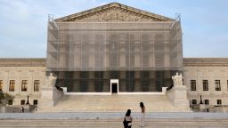People take photos at the US Supreme Court at dusk on June 10 in Washington, DC.