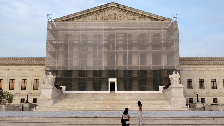 People take photos at the US Supreme Court at dusk on June 10 in Washington, DC.
