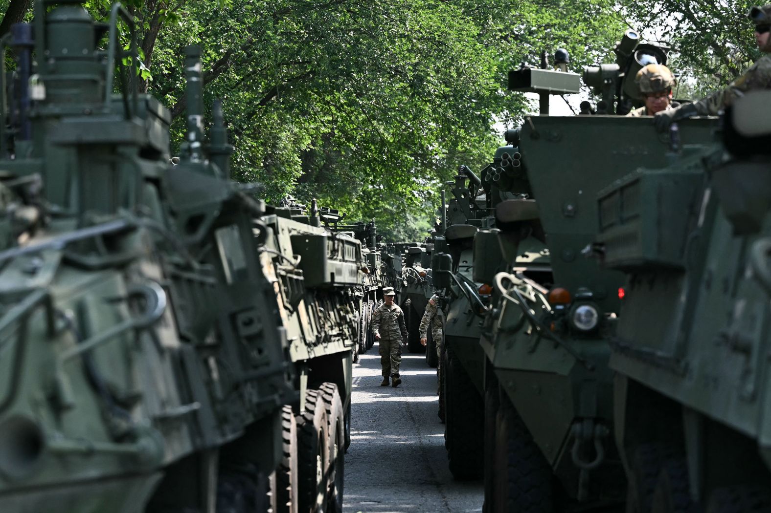 A US Army soldier walks between Stryker armored vehicles during a media preview at West Potomac Park in Washington, DC on Wednesday.