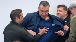 Sen. Alex Padilla is pushed out of the room as Homeland Security Secretary Kristi Noem holds a news conference in Los Angeles on June 12.