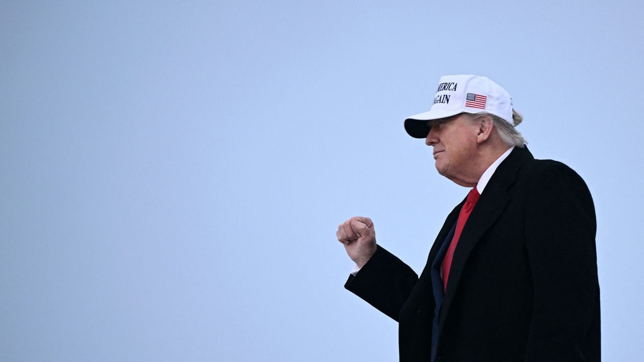 President Donald Trump raises a fist as he steps off of Air Force One upon arrival at Calgary International Airport, before the start of the G7 summit, in Calgary, Alberta, Canada, on June 15.