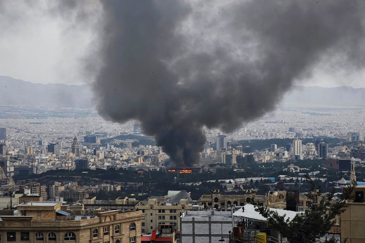 Smoke rises after a reported Israeli strike on a building used by Islamic Republic of Iran News Network, part of Iran's state TV broadcaster, on June 16, in Tehran, Iran.