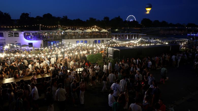 People attend France's annual street music festival, the Fete de la Musique, on the Seine river banks in Paris on June 21.