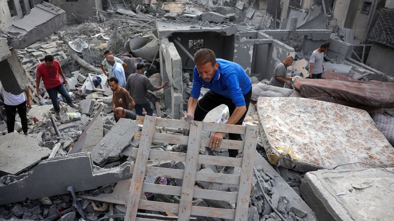 Palestinians search for survivors and casualties in the rubble of the Abu Nadi home which was hit in an Israeli strike west of Jabalia in the northern Gaza Strip on June 23.