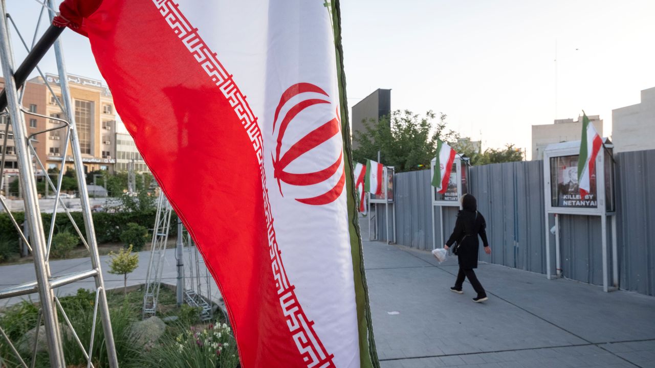 An Iranian woman walks in a square in downtown Tehran on June 23.