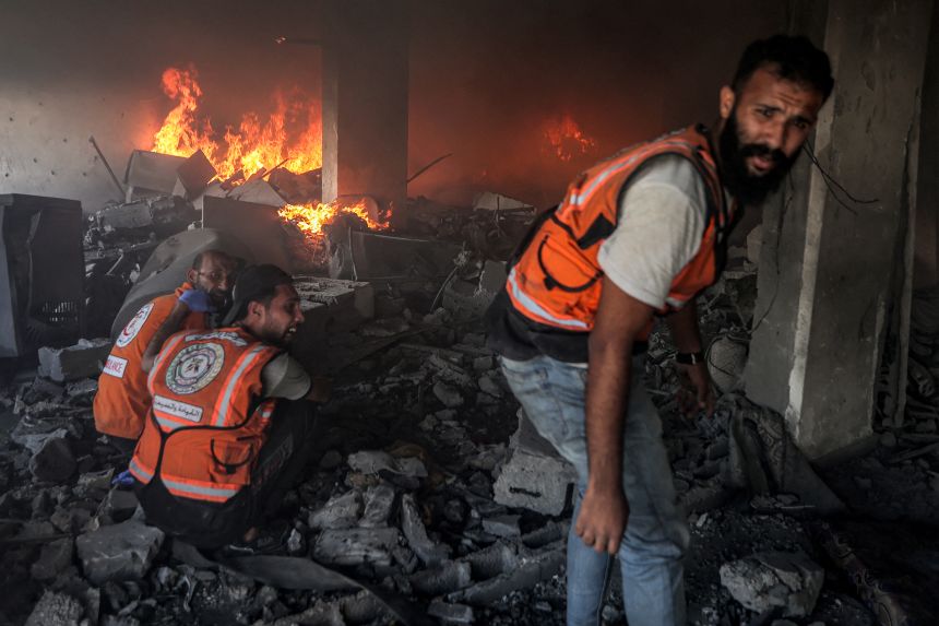 Palestinian civil defense try to extinguish a fire at a building hit by an Israeli strike in Gaza City in the central Gaza Strip, on July 2 amid the ongoing conflict between Israel and the Palestinian Hamas militant group. 