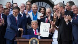 President Donald Trump signs his tax and budget bill from the South Lawn of the White House on July 4, in Washington, DC.