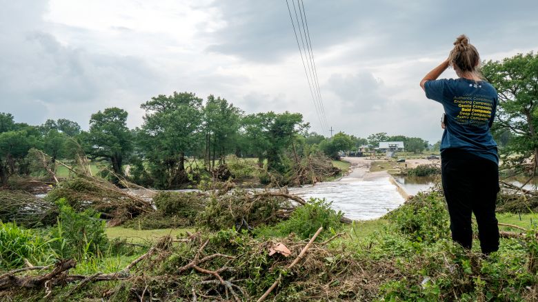 Kerrville resident, Nicole, stands on the banks of the Guadalupe River on July 6 in Center Point, Texas.