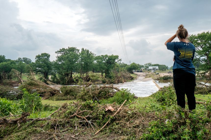 Kerrville resident, Nicole, stands on the banks of the Guadalupe River on July 6 in Center Point, Texas.