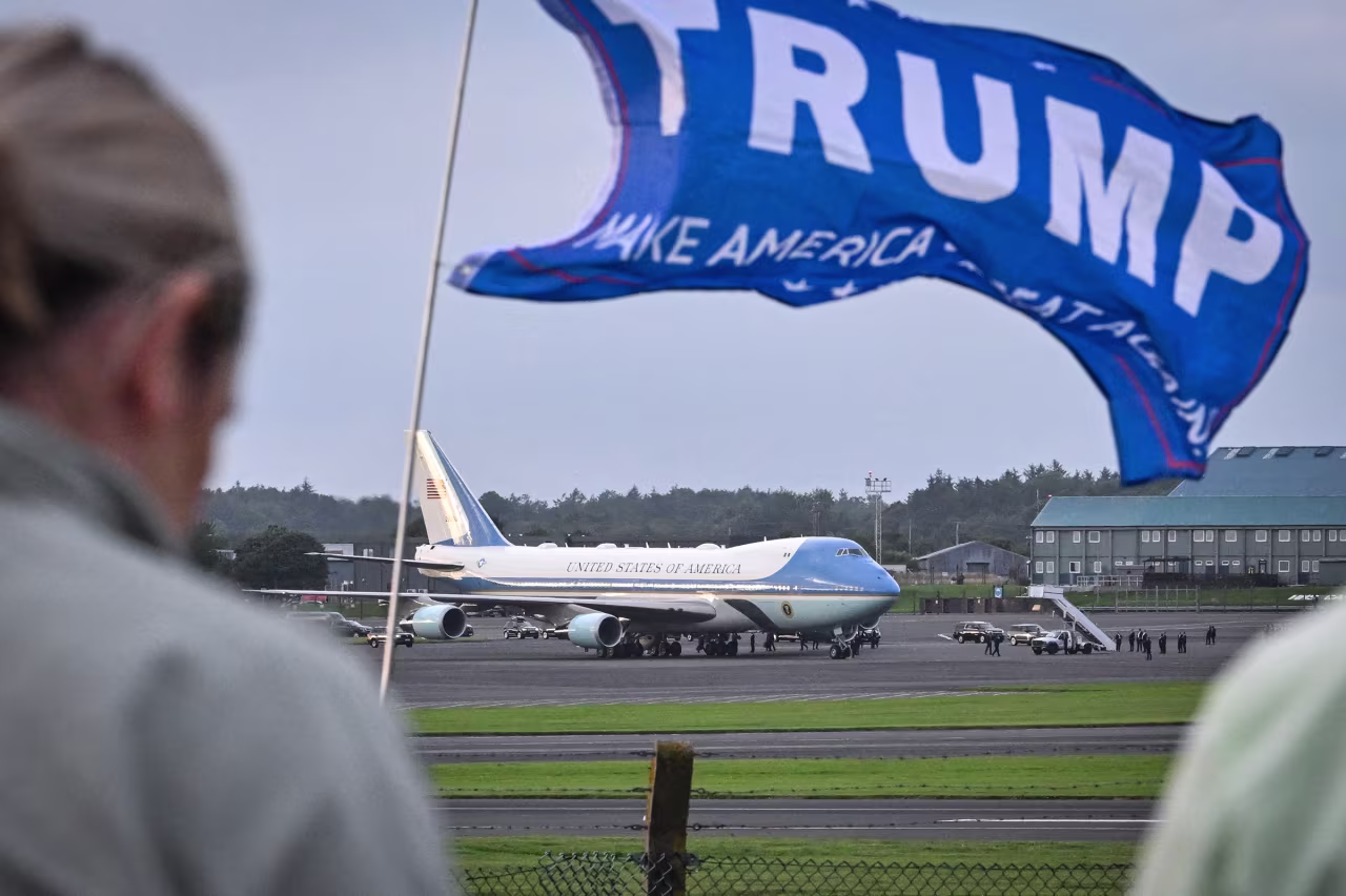 A pro-Trump flag waves in the wind as President Donald Trump arrives at at Prestwick airport, south of Glasgow, Scotland, on July 25.