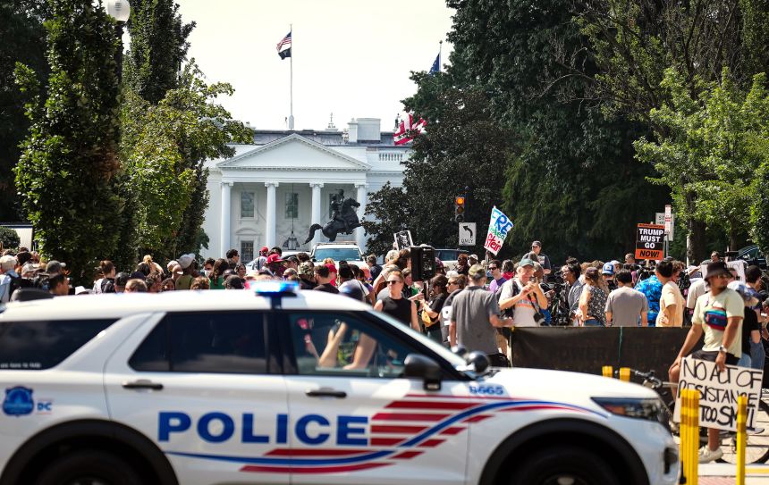 A DC Metropolitan Police Department car is parked near a rally against the Trump Administration's federal takeover of the District of Columbia, outside of the AFL-CIO on August 11 in Washington, DC.
