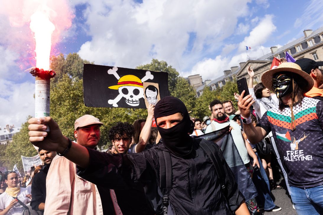 Protesters hold a torch in between 
