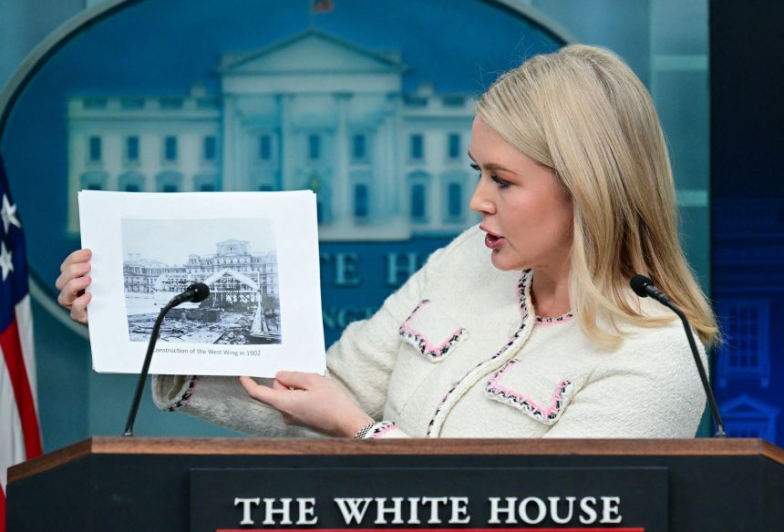White House Press Secretary Karoline Leavitt holds up a picture of a past White House renovation project as she speaks during the press briefing in Washington, DC, on Thursday.
