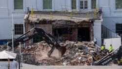 An excavator works to clear rubble after the East Wing of the White House was demolished on October 23, 2025 in Washington, DC. The demolition is part of U.S. President Donald Trump's plan to build a ballroom reportedly costing at least $250 million on the eastern side of the White House.