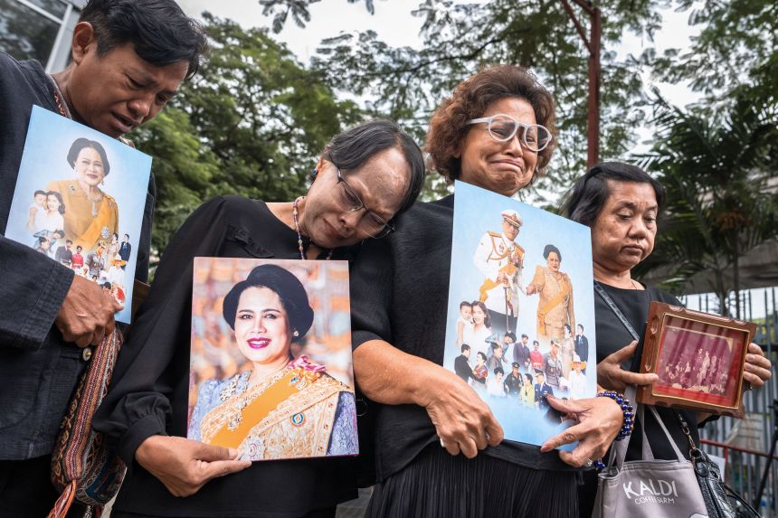 People holding portraits of former Queen Sirikit gather in front of Chulalongkorn Hospital where she died in Bangkok on October 25th.