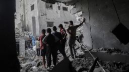 Palestinians look out from a damaged building following an Israeli airstrike at the Al-Shati refugee camp in Gaza City, northern Gaza, on Wednesday, Oct. 29, 2025.