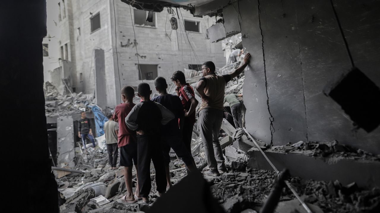 Palestinians look out from a damaged building following an Israeli airstrike at the Al-Shati refugee camp in Gaza City, northern Gaza, on Wednesday, Oct. 29, 2025.