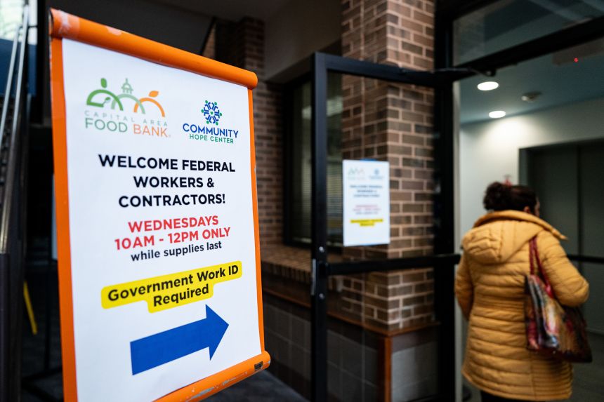 A furloughed federal worker arrives to pick up boxes of food items at a Capital Area Food Bank distribution site in Gaithersburg, Maryland, on October 29, 2025.