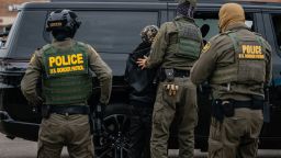 Federal immigration agents arrest a man in the parking lot of an H-Mart grocery store on October 31, 2025, in Niles, Illinois. Chief Patrol Agent of the El Centro Sector for U.S. Customs and Border Protection Gregory Bovino was among the agents carrying out the arrest as part of President Donald Trump's administration's "Operation Midway Blitz," an ongoing immigration enforcement surge across the Chicago region.