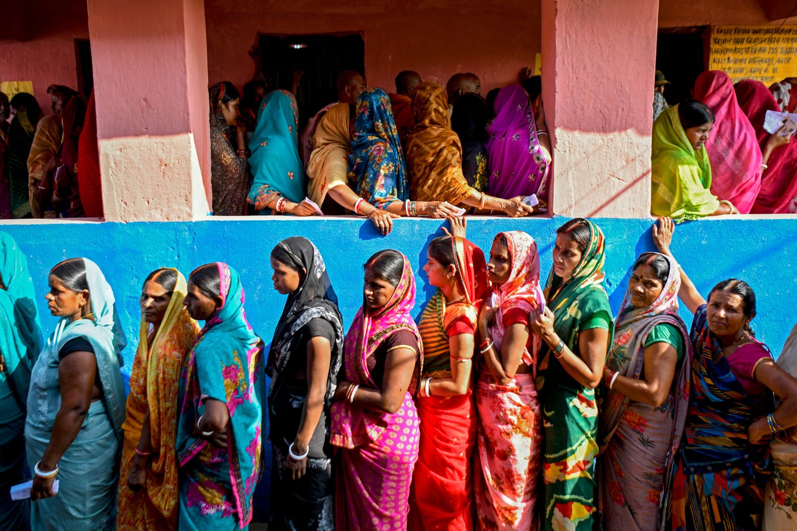 Women stand in line to cast their ballots during assembly elections in the Vaishali district of India on Thursday, November 6.