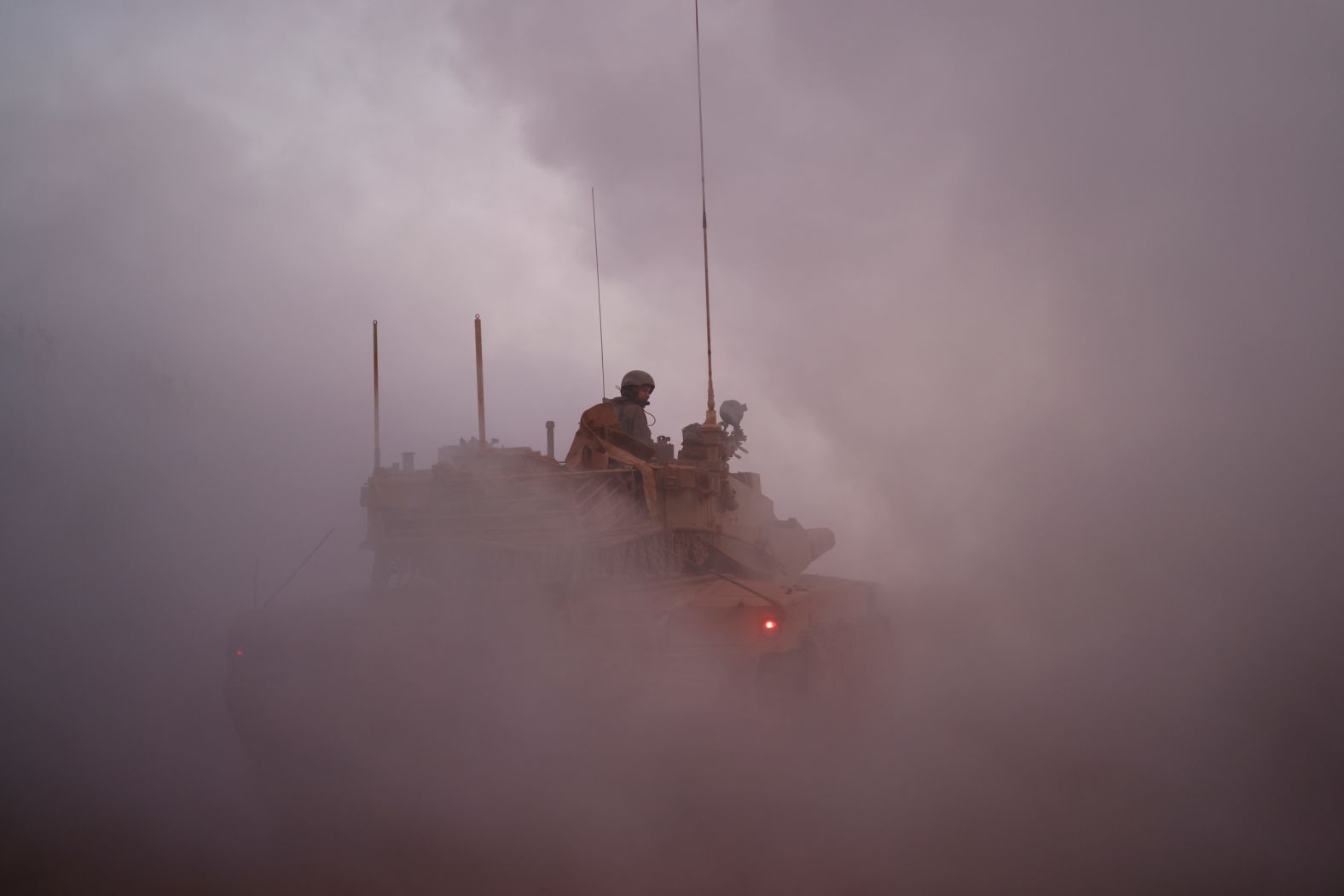 An Israeli soldier rides in a tank in northern Israel, along the border with southern Lebanon on Thursday, November 6. The Israeli military <a href="index.php?page=&url=https%3A%2F%2Fwww.cnn.com%2F2025%2F11%2F06%2Fmiddleeast%2Fisrael-strikes-lebanon-hezbollah-intl">carried out a series of strikes across southern Lebanon that day</a>, saying it was targeting Hezbollah in response to what it described as the militant group’s attempts to rebuild operations in the region. In a statement, Hezbollah accused Israel of repeatedly violating a ceasefire reached in November 2024 and of “blackmailing” the Lebanese government into recognizing Israel.