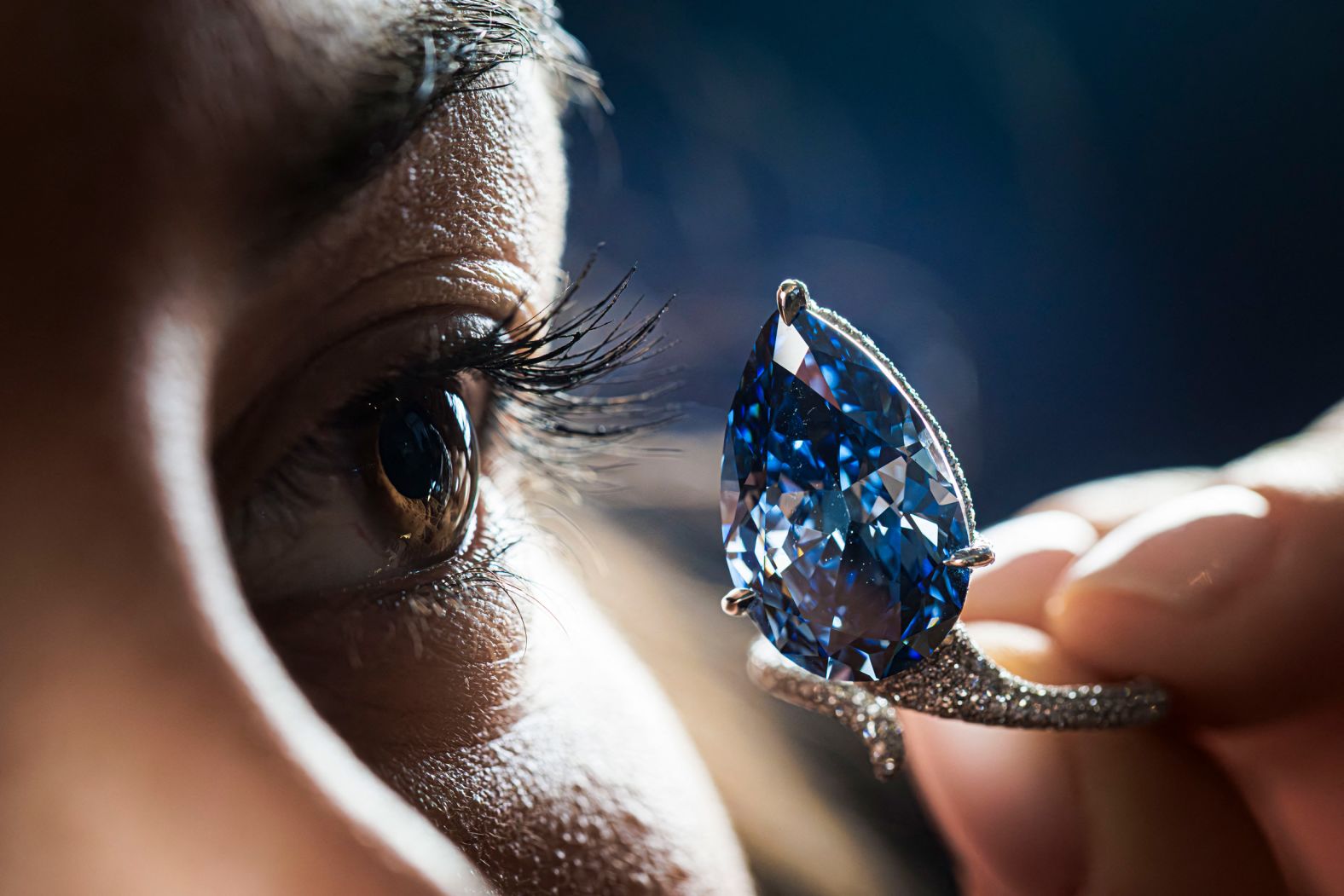 A staff member from the Christie’s auction house shows off the “Mellon Blue,” a 9.51-carat vivid blue diamond, during a presentation in Geneva, Switzerland, on Friday, November 7. The diamond <a href="index.php?page=&url=https%3A%2F%2Fapnews.com%2Farticle%2Fswitzerland-diamond-auction-christies-mellon-blue-f639c0471bdc94e531651550b91d77d4" target="_blank">sold for $25.6 million</a> this week.