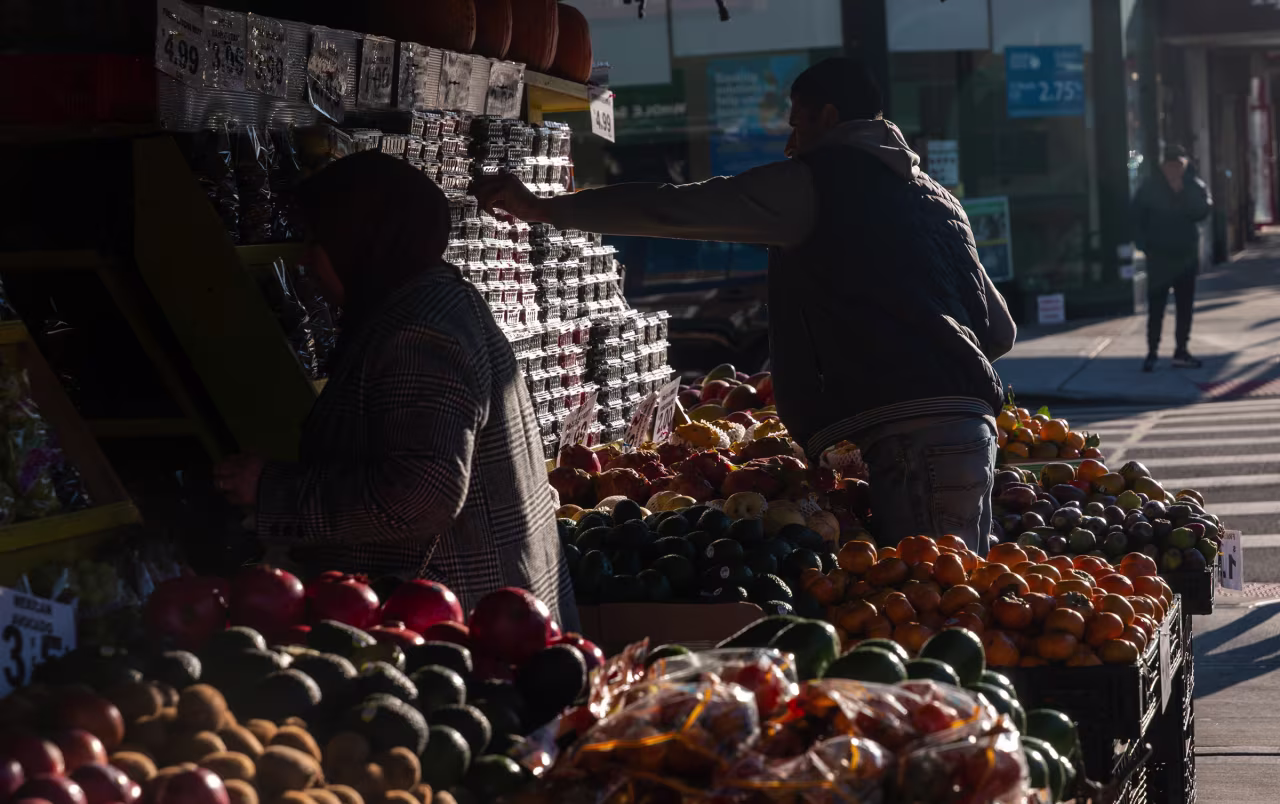 A man stacks fruit at a grocery store on November 6, in the Brooklyn borough of New York City.