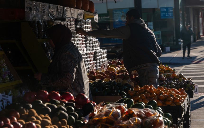 A man stacks fruit at a grocery store on November 6, in the Brooklyn borough of New York City.