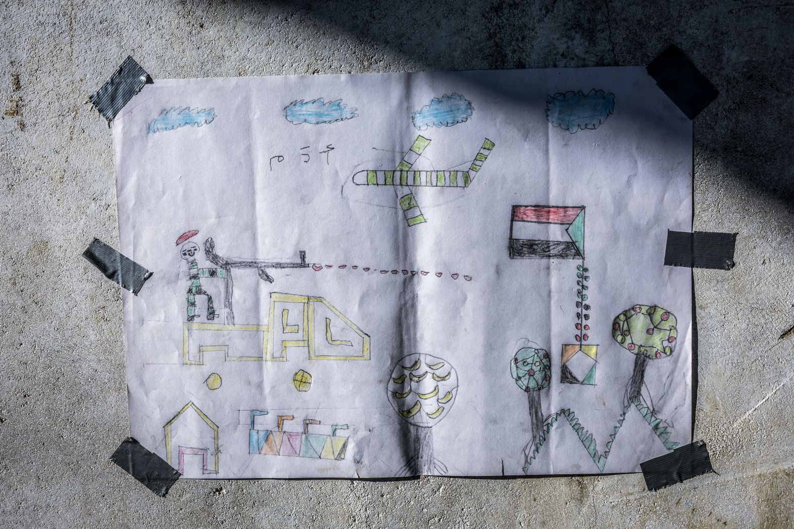 A drawing created by a young Sudanese refugee is displayed at the Tine transit camp in Chad on Monday, November 10. <a href="index.php?page=&url=https%3A%2F%2Fwww.cnn.com%2Finteractive%2F2025%2F05%2Fworld%2Fsudan-civil-war-cnnphotos%2F">Tens of thousands of people have died in Sudan</a> since fighting began in April 2023 between the country’s military and the paramilitary Rapid Support Forces.