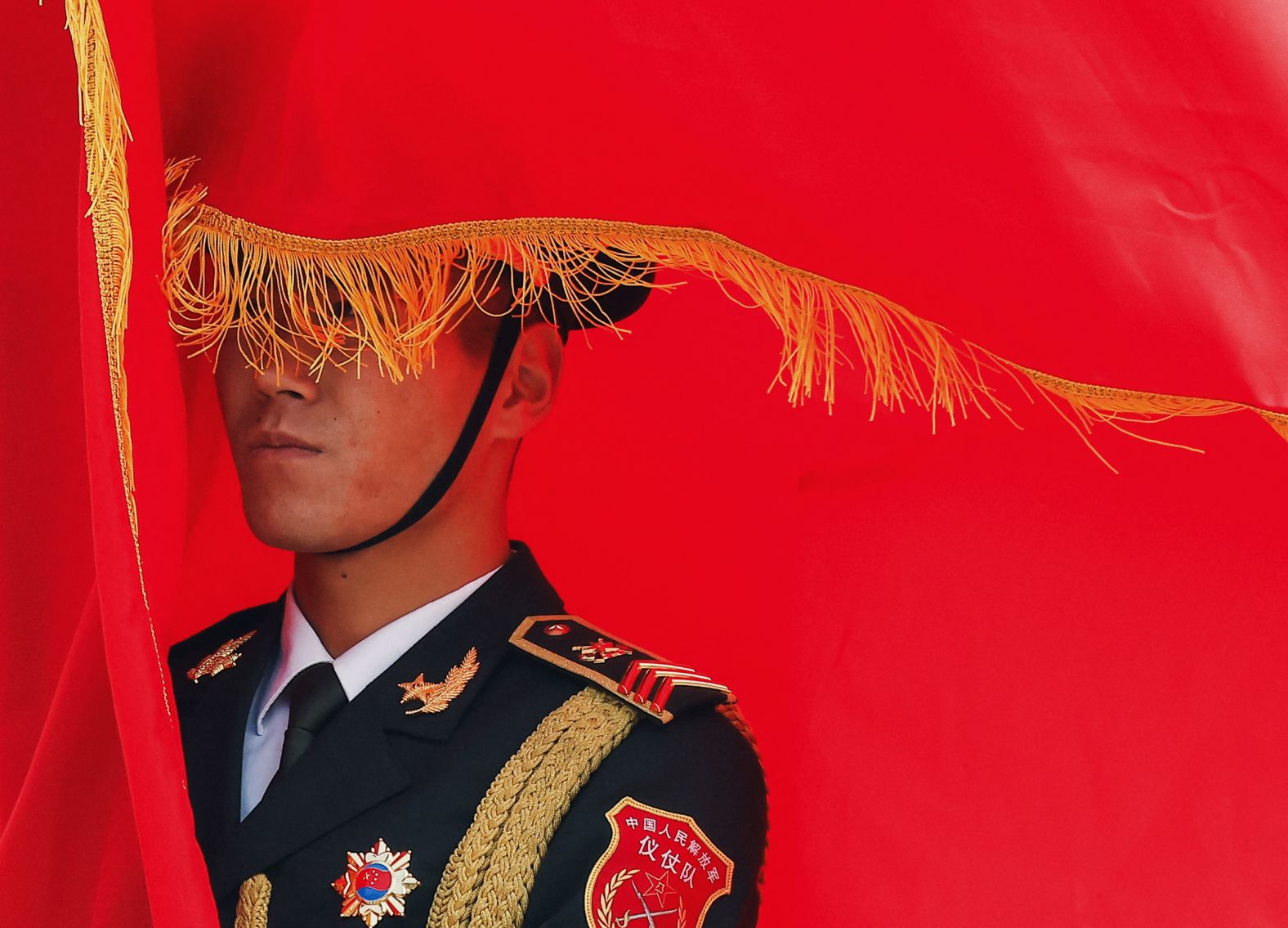 A member of a Chinese honor guard holds a flag on Wednesday, November 12, during a welcoming ceremony in Beijing for Spain’s King Felipe VI.