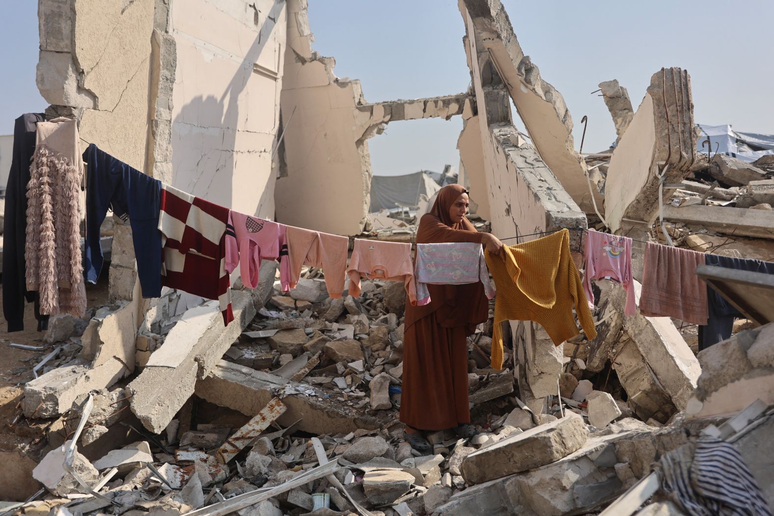 A Palestinian woman hangs clothes to dry amid the ruins of a building in Gaza City on Tuesday, November 18. Much of the city has been destroyed by Israeli bombardments since the October 7, 2023 attacks on Israel by Hamas.