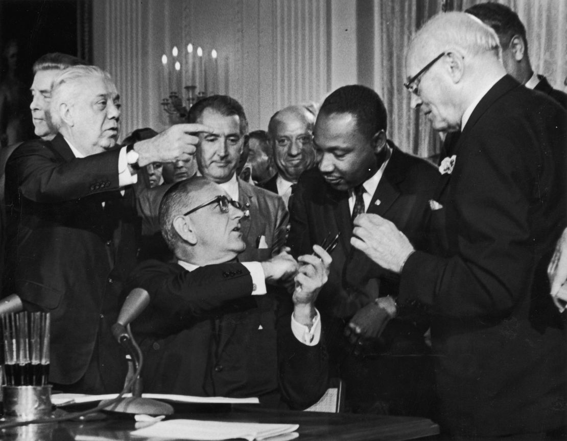President Lyndon B. Johnson shakes the hand of Dr. Martin Luther King Jr. at the signing of the Civil Rights Act.