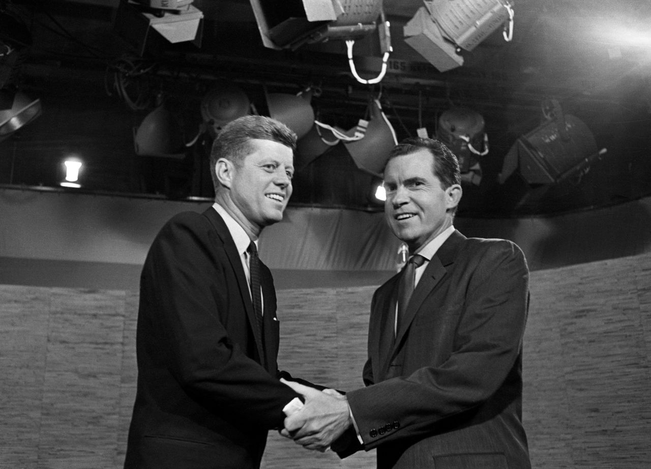 Presidential candidates John F. Kennedy and Richard Nixon shake hands after their televised debate in Washington, DC, on October 7, 1960.