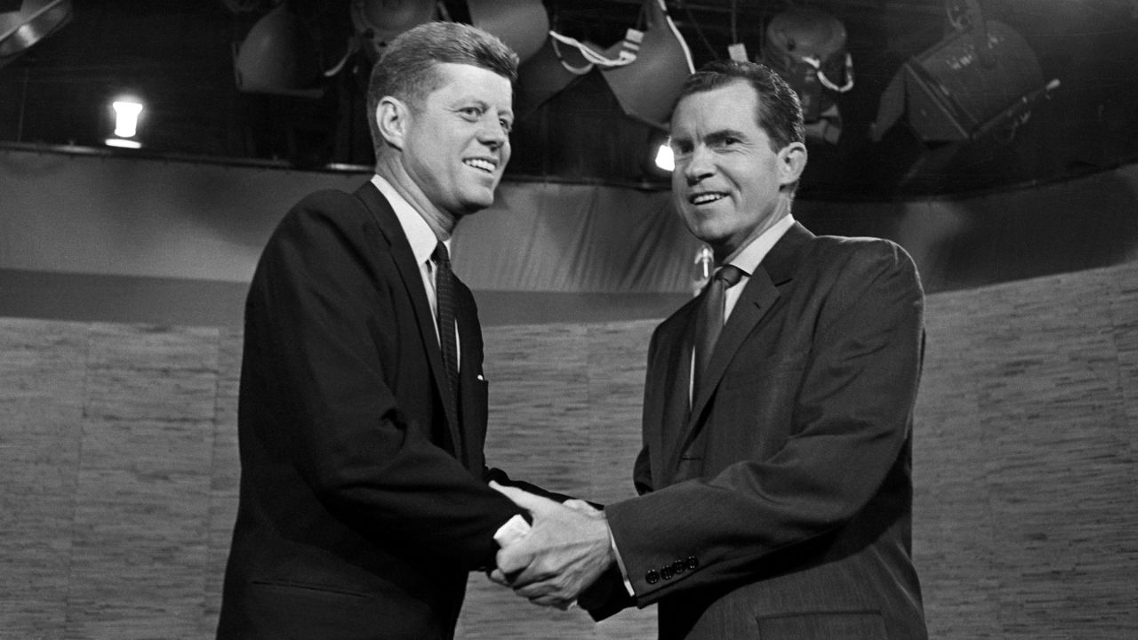 Presidential candidates John F. Kennedy and Richard Nixon shake hands after their televised debate on October 7, 1960 in Washington, DC.