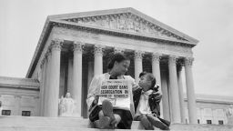 Nettie Hunt and her daughter Nickie sit on the steps of the U.S. Supreme Court. Nettie explains to her daughter the meaning of the high court's ruling in the Brown Vs. Board of Education case that segregation in public schools is unconstitutional. (Photo by UPI/Bettmann via Getty Images)