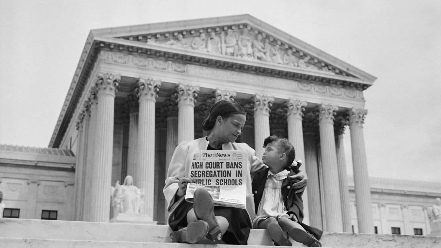 Nettie Hunt explains to her daughter Nickie the meaning of the high court's ruling in the Brown v. Board of Education as they sit on the steps of the US Supreme Court in May 1954.