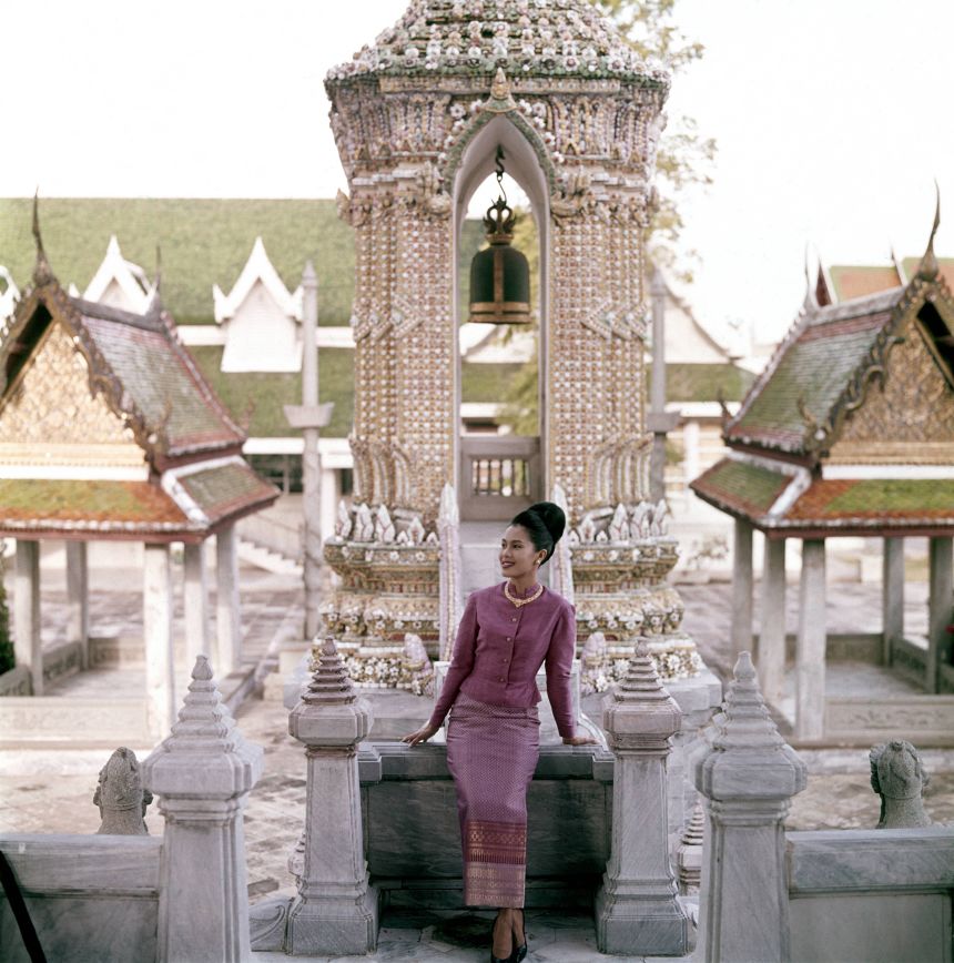 Thailand's Queen Sirikit stands in front of a porcelain-encrusted tower in one of the Grand Palace's many pavilions.