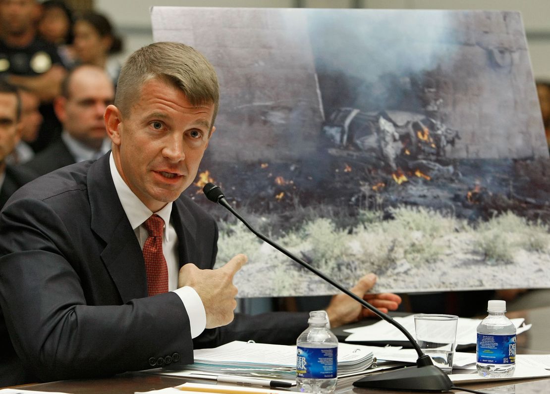 In this October 2007 photo, Erik Prince holds up a picture showing the affect of a car bomb while testifying during a House Oversight and Government Reform Committee hearing on Capitol Hill in Washington DC.