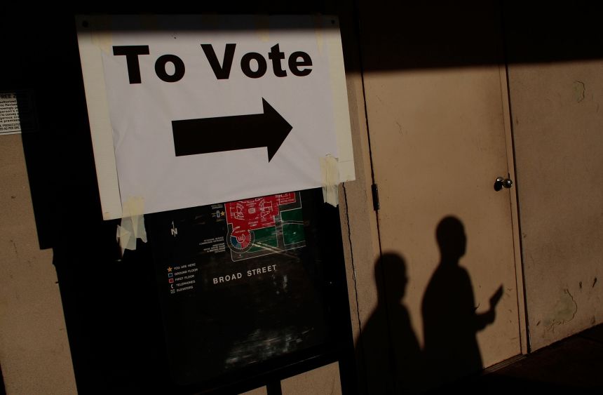 People walk towards a two-hour line to vote early for the 2008 presidential election in a downtown building October 31, 2008 in Columbus, Ohio.
