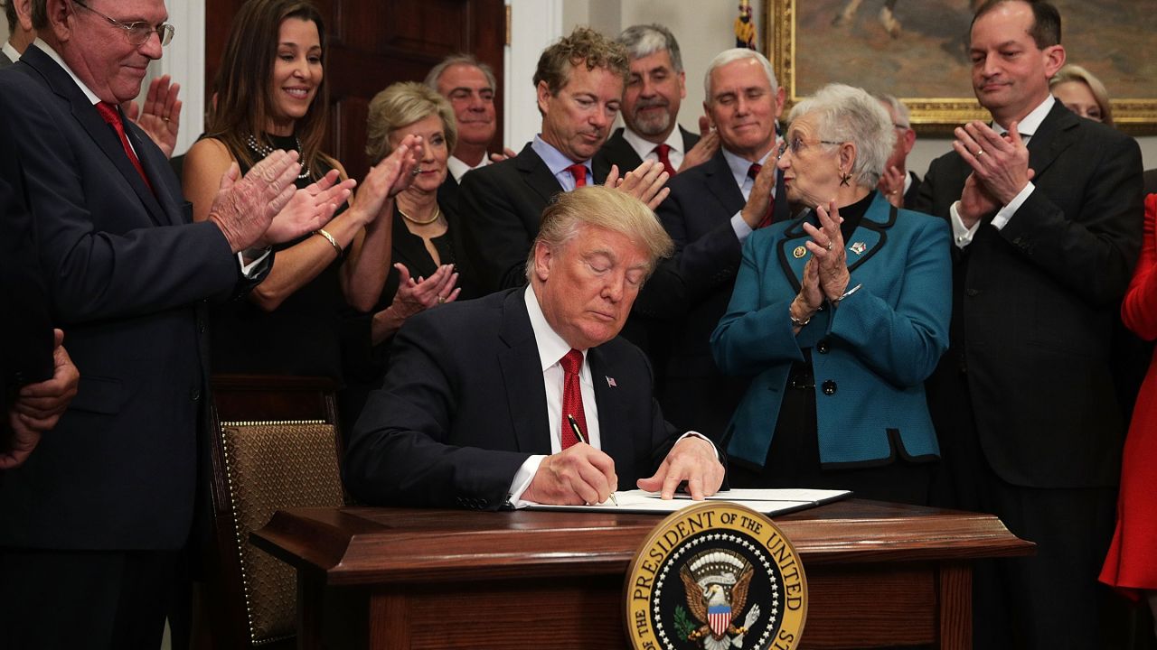 In this October 2017 photo, then-President Donald Trump signs an executive order to loosen restrictions on Affordable Care Act "to promote healthcare choice and competition" in Washington, DC.