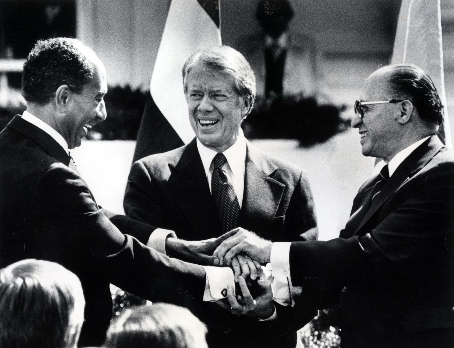 From left, Egyptian President Anwar Sadat, Carter and Israeli Prime Minister Menachem Begin join hands after the signing of peace accord ended 31 years of war between Egypt and Israel in March 1979. It was one of the highlights of Carter's presidency.