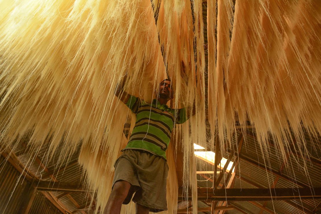 A worker arranges strands of vermicelli noodles to dry to make sheer khurma during Ramadan on the outskirts of Agartala, India, on May 24, 2018.