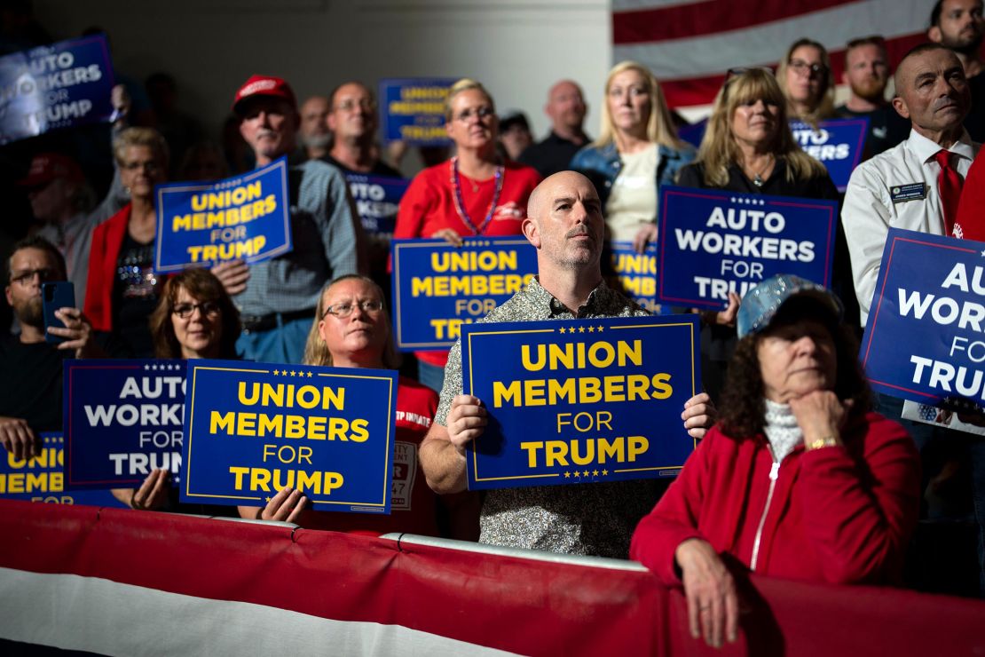 Attendees holding union signs at a campaign speech by Donald Trump at Drake Enterprises in Clinton Township, Michigan, in September 2023. 