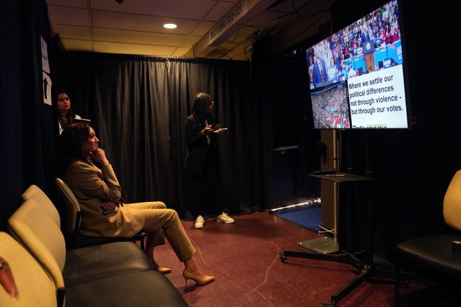 Vice President Kamala Harris and her chief of staff, Sheila Nix, watch her running mate Gov. Tim Walz of Minnesota, warming up the Glendale, Arizona crowd from backstage at their rally on August 9. 