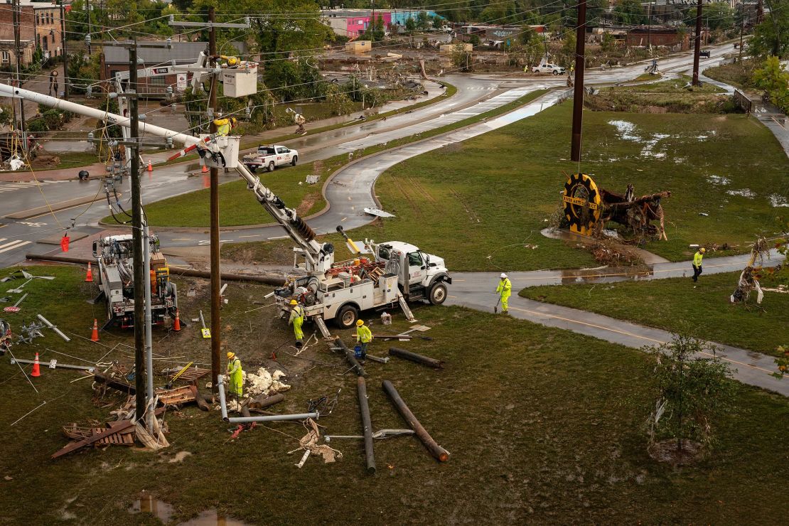 A crew works to repair damaged power lines in the River Arts District in Asheville, North Carolina, on September 30, 2024.